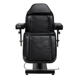 Black Pro Ink tattoo chair with cradle and adjustable armrests