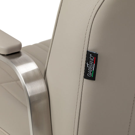 Beige Gabbiano Acri hairdressing chair with cushioned seat and backrest, adjustable height, and modern design.